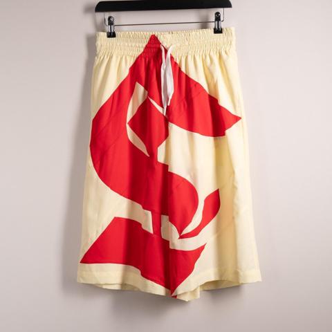 Stefan Cooke AW24 Gothic Shorts
Cream/Red
New with defects - Fabric has snagged slightly on the front of the shorts.

Key Details
- As seen in look 29 of the Autumn Winter 2024 runway show. 
- Super intricate and detailed pattern cutting.
- Material: 100% Polyester 
- Made in: United Kingdom

Measurements (approx laid flat)
Waist: 36cm
Rise: 37cm
Inseam: 32cm
Leg Opening: 35cm