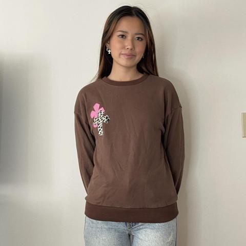 brown sweater with cross patch