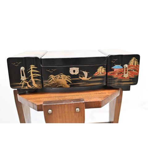 Vintage Japanese Mid Century Black Lacquer Jewelry Box Sankyo Music Box Fuji

Vintage Japanese mid-century jewelry box features a stunning black lacquer finish with intricate hand-painted gold and red landscape scenes, including Mount Fuji, pagodas, and sailboats. The interior is lined with rich blue velvet and includes a built-in mirror, multiple compartments, and two pull-out side drawers for organized storage. While the original Sankyo music box mechanism is currently non-functional and will not wind, this piece remains a beautiful decorative vanity accent or project piece for restoration. Crafted from wood with traditional lacquerware techniques, it showcases classic Showa-era aesthetic charm.

Measurements:
• Length: 13.5"
• Width: 6.5"
• Height: 4.25"

#MidCentury #Japanese #Asian