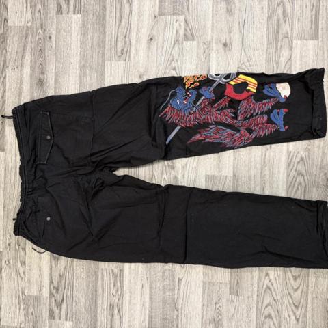 **Maharishi Sea Dragon Snopants – Black**

Rare Maharishi Sea Dragon Snopants in black featuring the signature embroidered Sea Dragon design.

Loose, baggy Snopant silhouette with a strong military-inspired Maharishi aesthetic. Distinctive embroidered dragon detailing makes these a standout designer streetwear piece.

**Details:**

* Maharishi
* Sea Dragon embroidery
* Black
* Snopant / loose fit
* Men's / unisex
* Designer streetwear
* Military-inspired
* Embroidered detailing
* Multiple pockets
* Adjustable waist
* [Large]
* [Great Condition]
Genuine Maharishi.