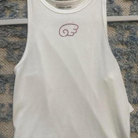 Sandy Liang white tank top. Bedazzled detail. Has been worn since pictures so no longer NWT !!
#sandyliang #designer