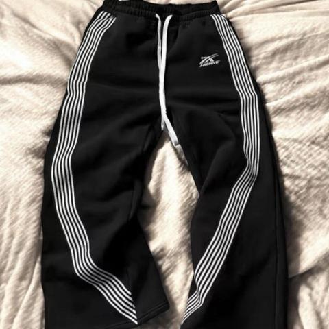 Black archive sweatpants with white stripes down the sides #archive #archivesweatpants #blackandwhitesweatpants #sweatpants
